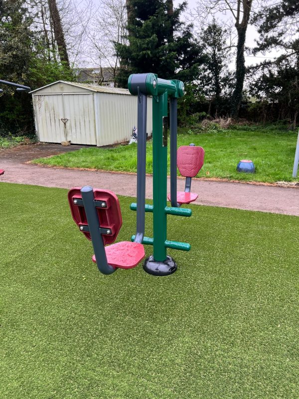 A double squat push on artificial grass.